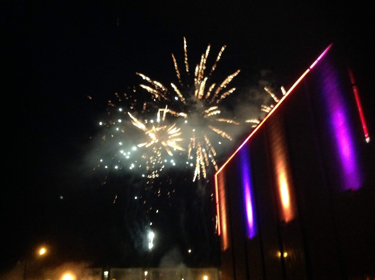 Outdoor event fireworks display with architectural uplighting